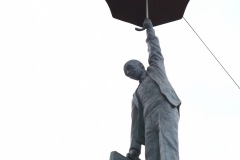 Man Hanging From an Umbrella